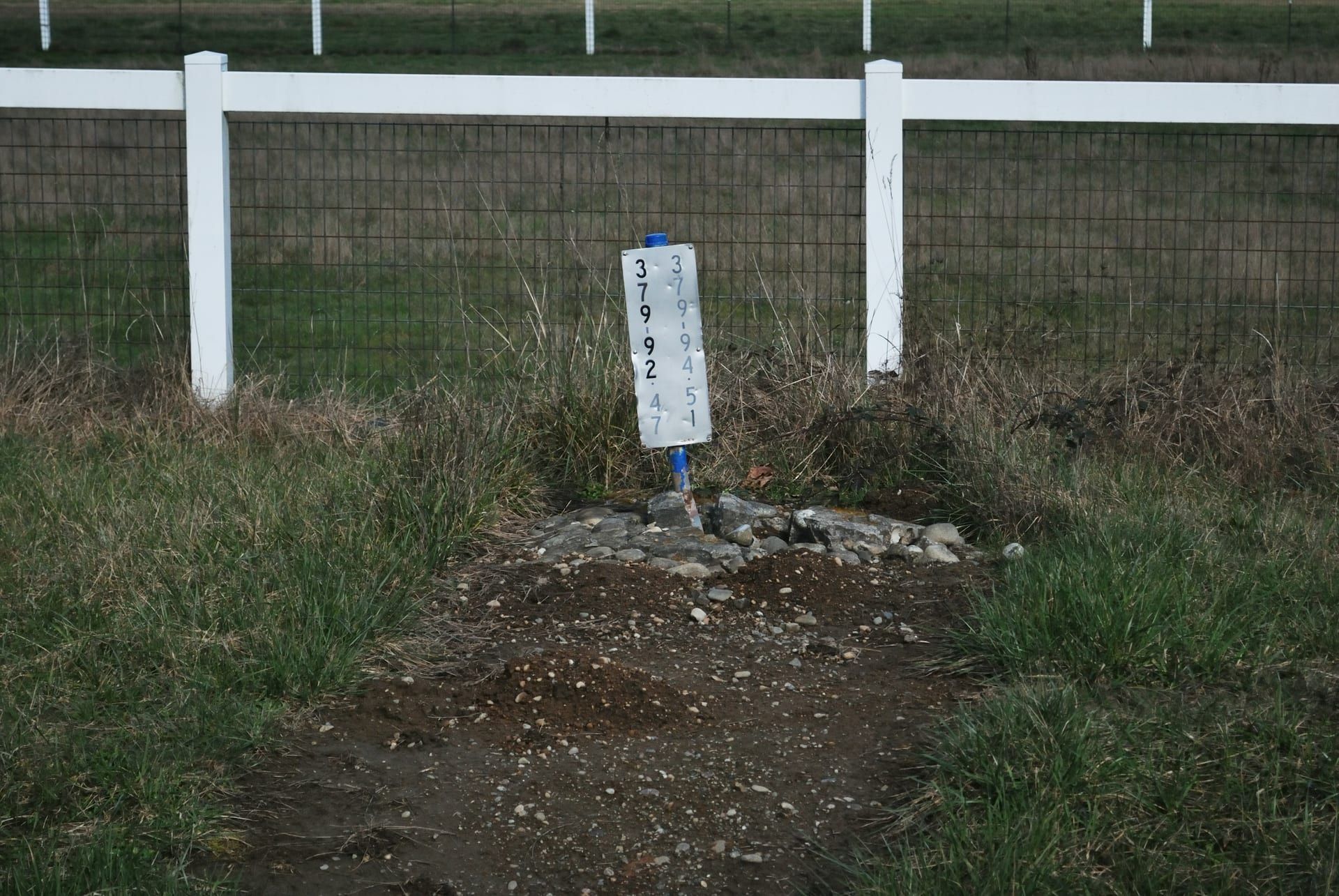 A fence post set in a concrete footing