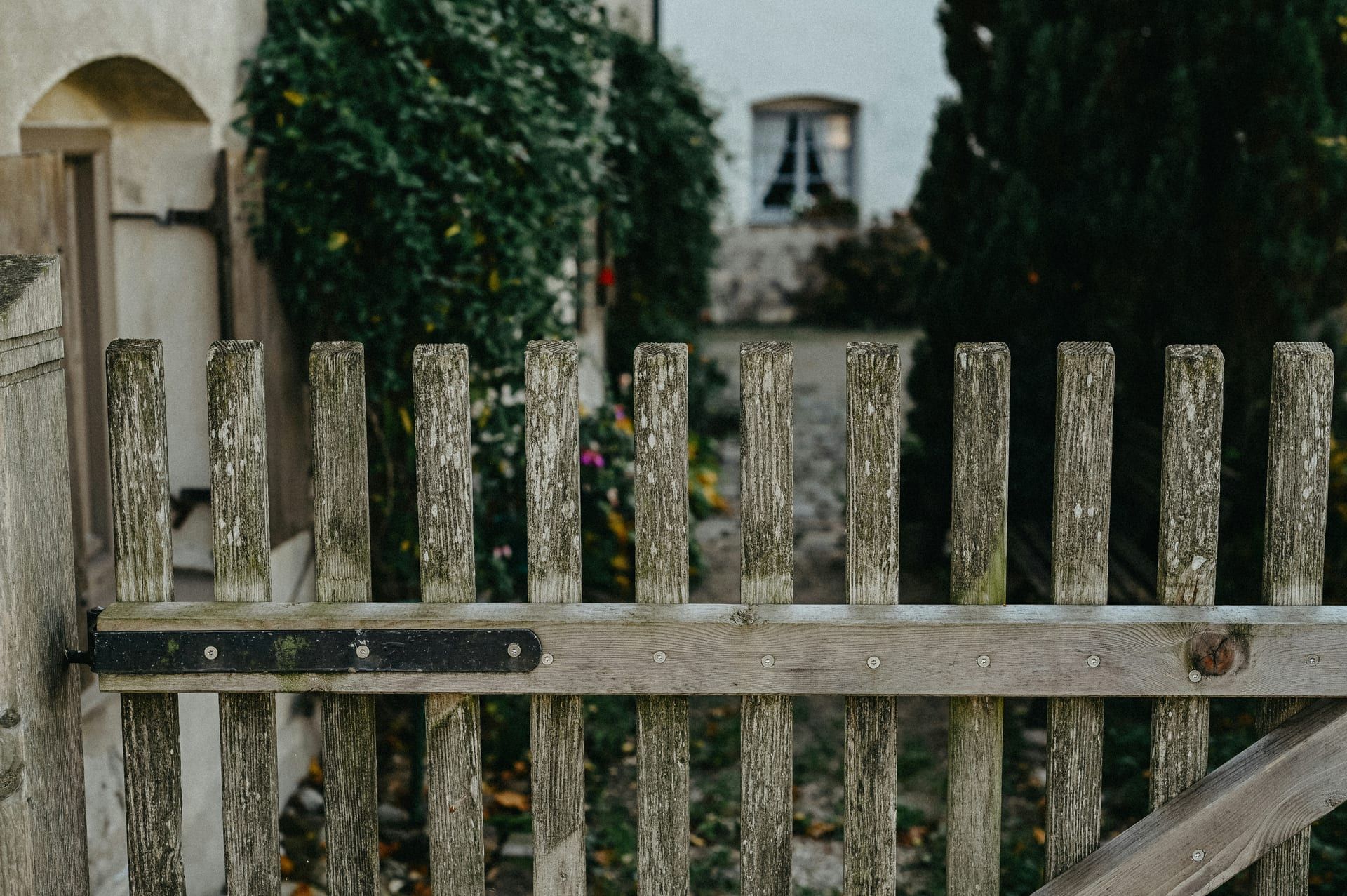 A grayed, weathered wood fence that was not maintained